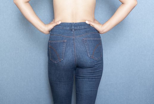 Woman showing back of jeans pants and sexy bottom