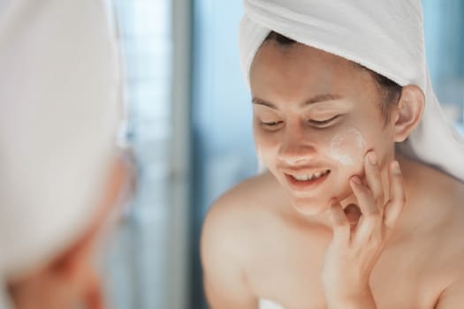 Close up woman looking her face in the mirror with smiling after bath, health care and beauty