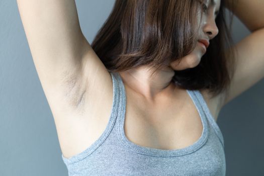 Women problem black armpit lying on white bed background for skin care and beauty concept, selective focus