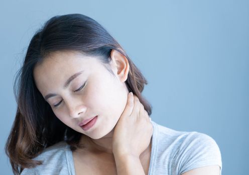 Closeup woman holding neck with pain after waking up on bed, healthy care and medical concept