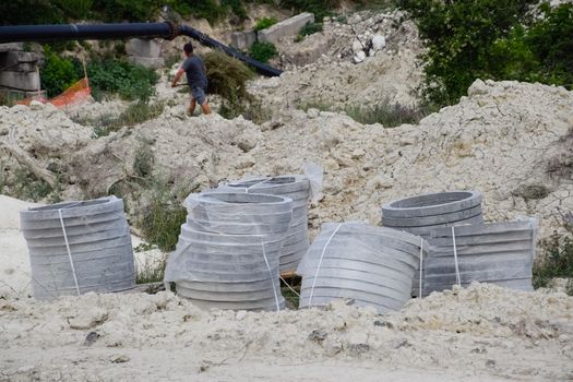 Iron concrete rings. Construction of a sewerage system.