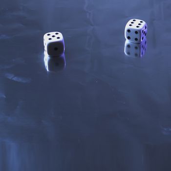 Two dice on silver background, static