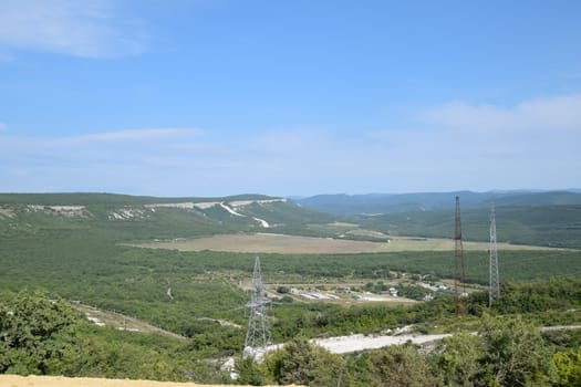 Landscapes of Crimean nature. Fields and hills visible from car window from the road.