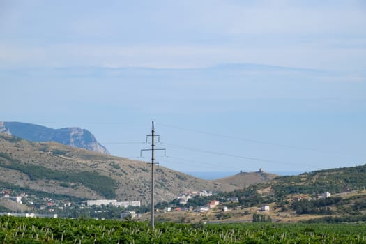 Landscapes of Crimean nature. Fields and hills visible from car window from the road.