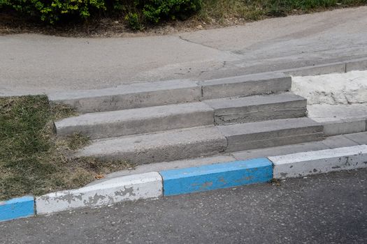 Steps on the sidewalk. Concrete steps in the park.