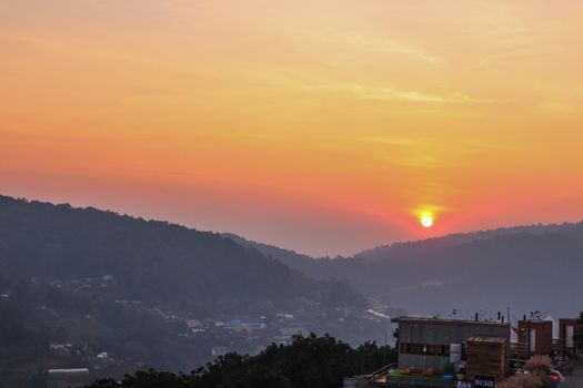 Colorful sunset over the mountain hills in a thai village near mountains in Chiang Mai, Thailand. The mountain scenery view