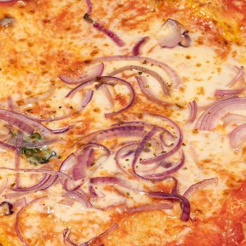 Close up shot of pizza with onions, detail of typical Italian dish, food photography