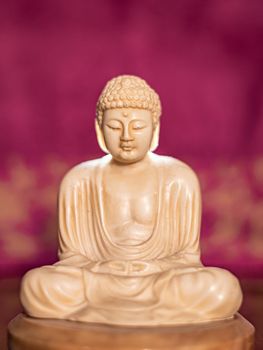 Statuette of Gautama Buddha in light marble in a prayer position, Dhyana-mudrain Buddha Shakyamuni in meditation