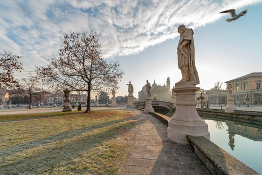 Prato della Valle, square in the city of Padua with the Memmia island surrounded by a canal surrounded by 87 statues, Italian cityscape