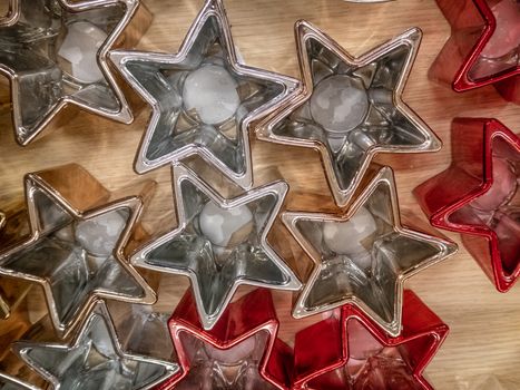 Set of star shaped Christmas candle holders, decorations in red and silver colors