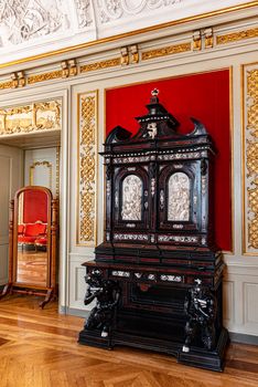 Interiors of the royal halls in the Christiansborg Palace in Copenhagen in Denmark, ancient carved wooden sideboard
