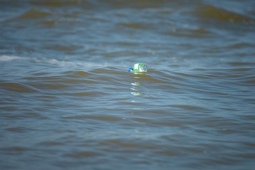 Plastic water bottle floating on the ocean