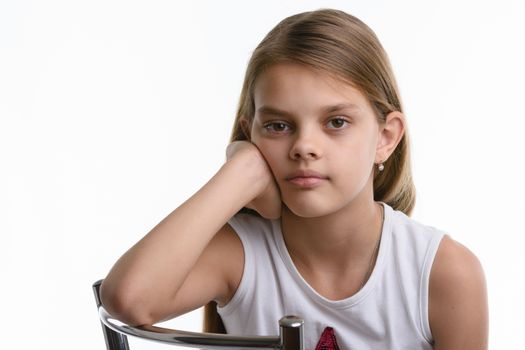 Portrait of a pensive ten year old girl on a white background