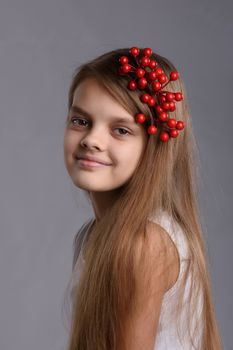 Portrait of a ten year old girl with a bunch of berries in her hair
