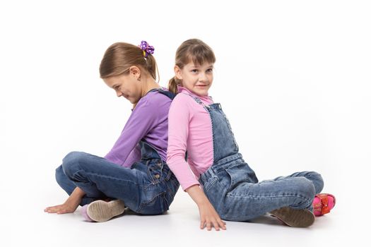 Sisters quarreling pushing each other's backs