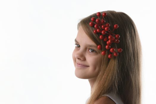 Closeup portrait of a ten year old girl with a bunch of berries in her hair