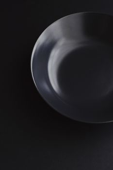 Empty plates on black background, premium dishware for holiday dinner, minimalistic design and diet concept