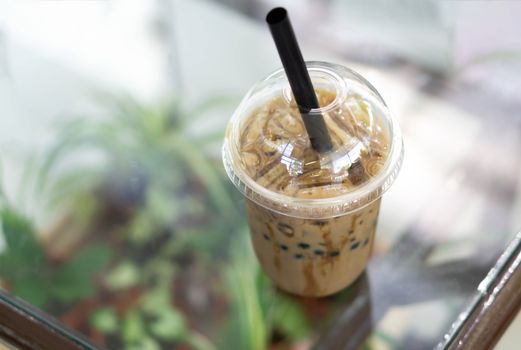 Closeup ice coffee on wood table with nature background