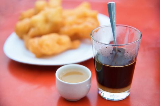 Traditional coffee with Chinese breadstick and Sweetened condensed milk in the Morning. Selective focus