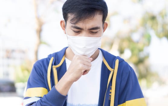 Closeup man wearing face mask for protect air polution or colona virus, health care and medical concept