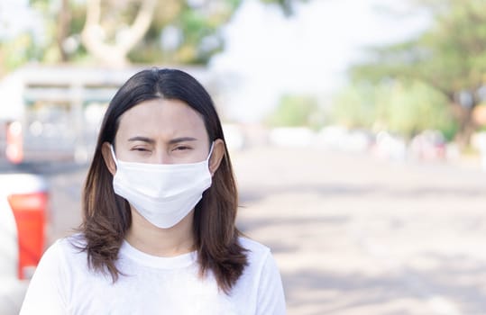 Closeup woman wearing face mask for protect air polution or colona virus, health care and medical concept