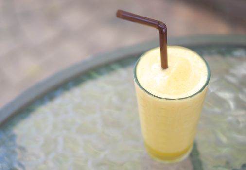 Closeup passion fruit smoothie  with green nature background, selective focus