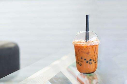 Closeup thai tea on wood table with nature background