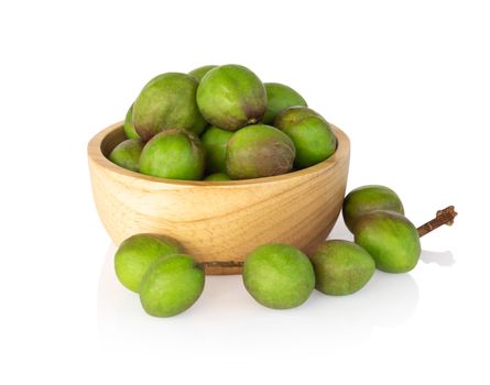 Chebulic Myrobalans in wood bowl isolated on white background, herb and medical