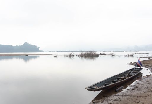 Beauty nature landscape with boat in the river and  mountain with fog in the morning, relax concept
