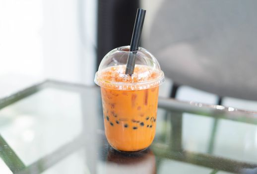 Closeup thai tea on wood table with nature background