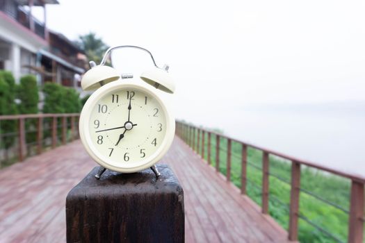 Alarm clock with nature and fog background in the morning