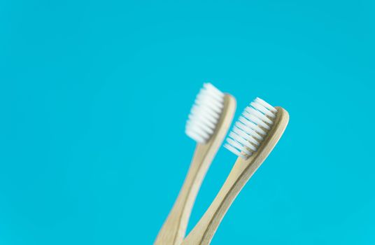 Close up wooden toothbrush on blue background, selective focus