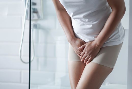 Close up woman stomachache with toilet in the morning, health care concept, selective focus