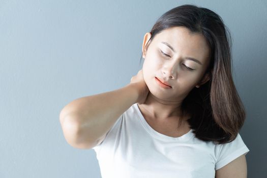 Closeup woman holding neck with pain after waking up on bed, healthy care and medical concept