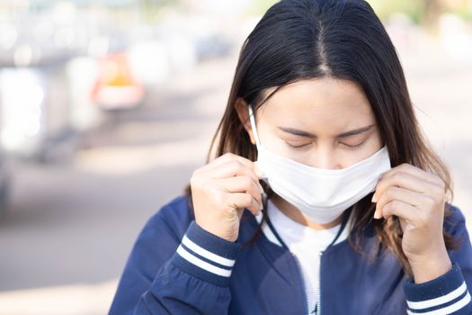 Closeup woman wearing face mask for protect air polution, health care and medical concept