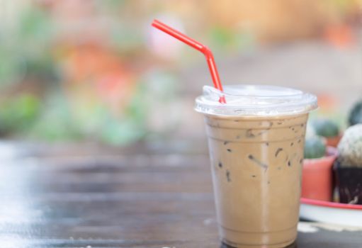 Close up glass of ice cappuccino coffee on wood table  background, selective focus