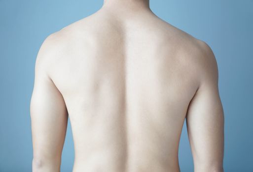 Back of man on blue background, beauty healthy skin care for men concept