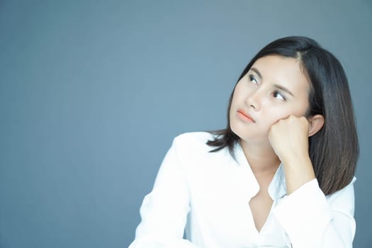 Woman thinking and looking something with blue background