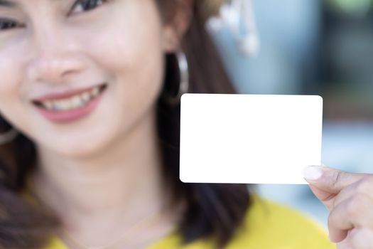 Closeup woman showing empty white credit card with smile face