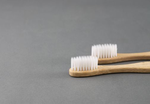 Close up wooden toothbrush on grey background, selective focus