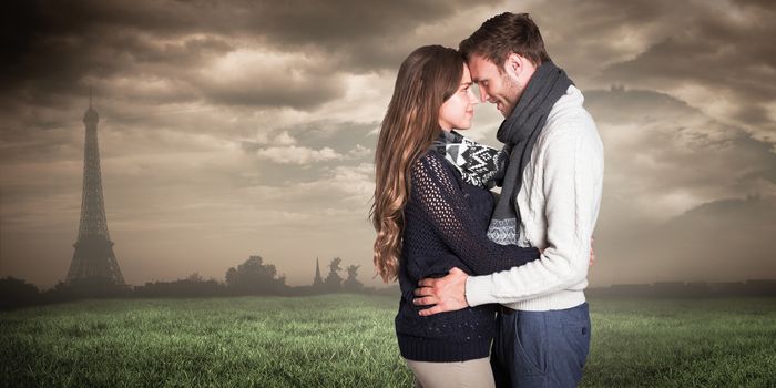 Side view of young couple embracing against paris under cloudy sky