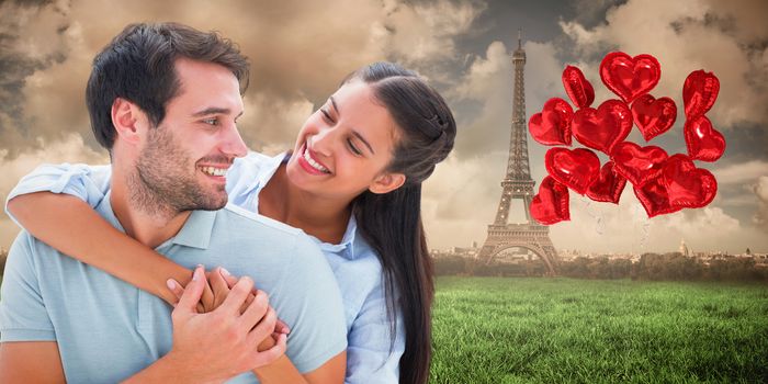 Cute couple smiling at each other against paris under cloudy sky