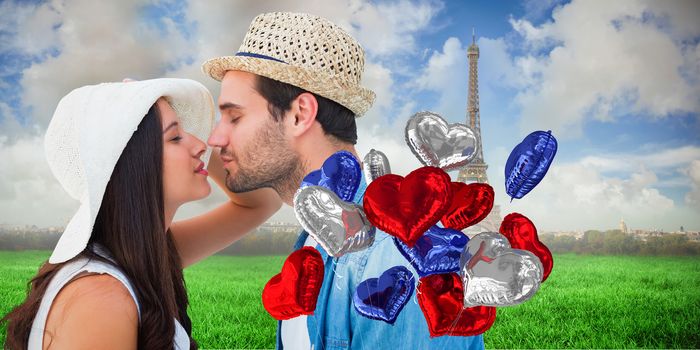 Happy hipster couple about to kiss against eiffel tower