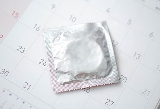 Closeup  condom  on calendar background, health care concept, selective focus
