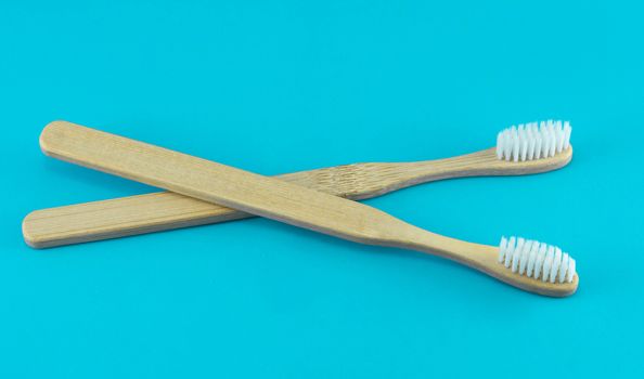 Close up wooden toothbrush on blue background, selective focus