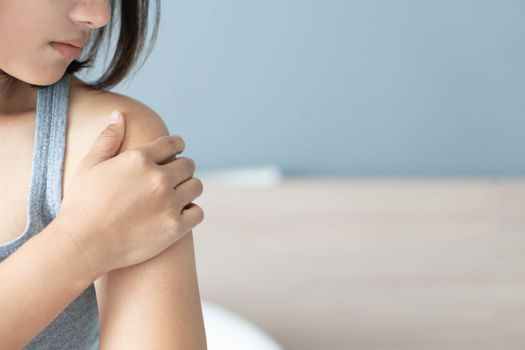 Closeup woman hand holding shoulder with pain on white background