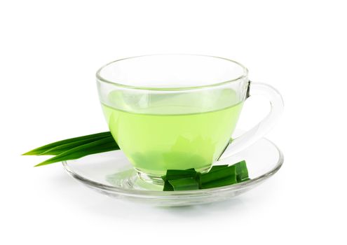 Glass of pandan juice with green leaves isolated on white background