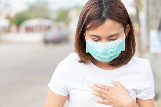 Closeup woman wearing face mask for protect air polution, health care and medical concept