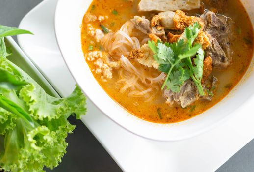 Rice noodle soup with Cooked Liver in  bowl on table, selective focus