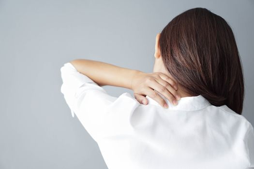 Closeup woman holding neck with pain, healthy care and medical concept